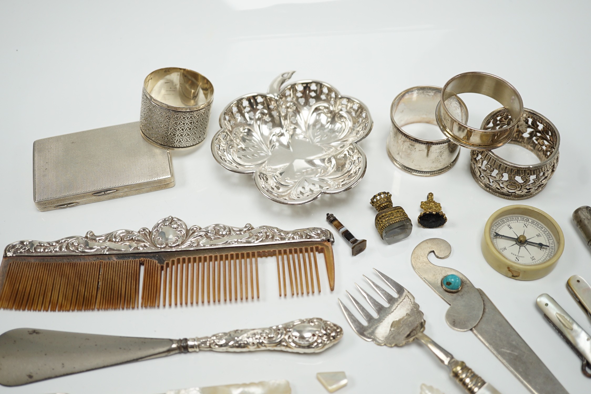 A group of assorted small silver and white metal items, including a small late Victorian clover shaped nut dish, napkin rings, pill box, etc and other items including two gilt metal mounted chalcedony fob seals.